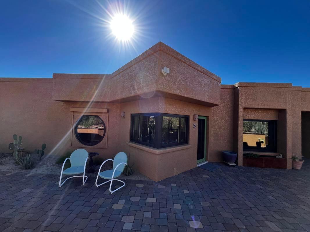 Freshly painted exterior of a Tucson home with smooth walls and crisp trim under a clear desert sky.