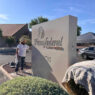 Painter from Piper Family Painting working on a commercial exterior sign for a Tucson painting project.