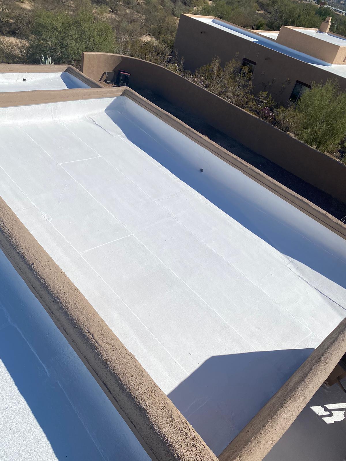 Piper Family Painting Company roof coatings on flat roof enhance energy efficiency and reflect sunlight in hot climates, showing professional application and UV protection.