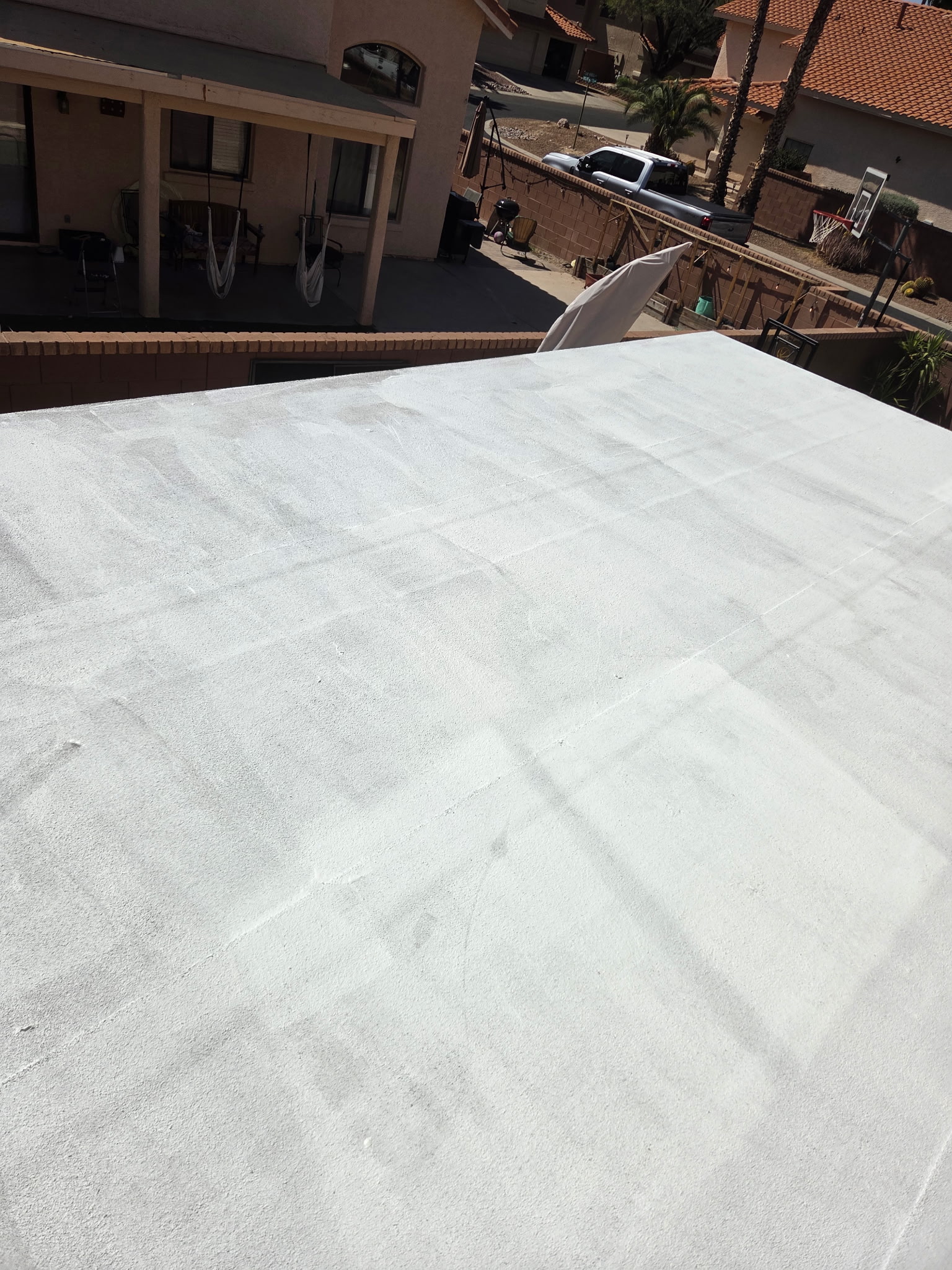 Recently coated roof treated by Piper Family Painting Company showcasing roof coatings for enhanced durability, UV protection, and energy efficiency.