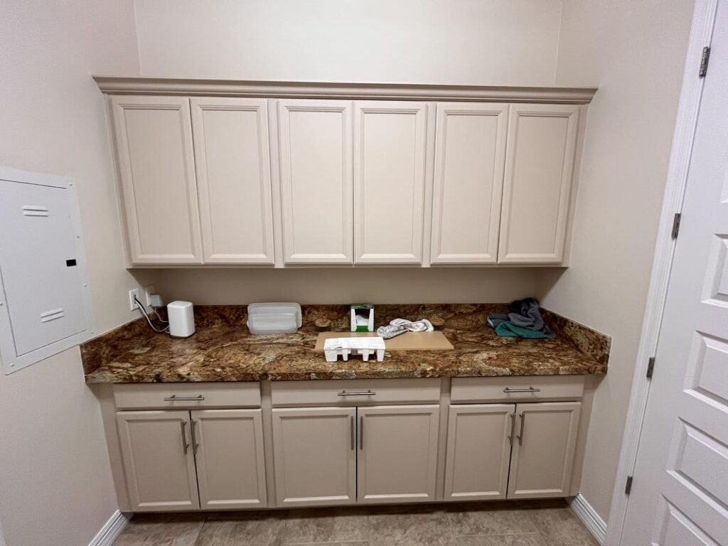 Interior cabinetry painted by Piper Family Painting Company showcasing expert Dove Mountain Painting Company craftsmanship in a clean, modern utility space.