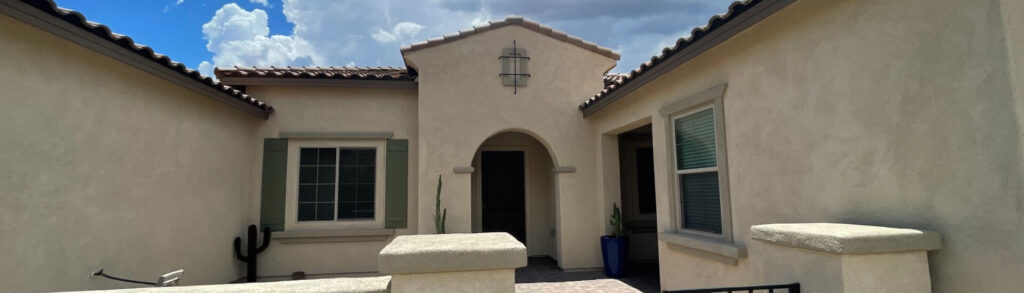 Beautiful cream stucco home painted by Dove Mountain Painting Company, showcasing Piper Family Painting Company's expert craftsmanship and Southwestern charm.