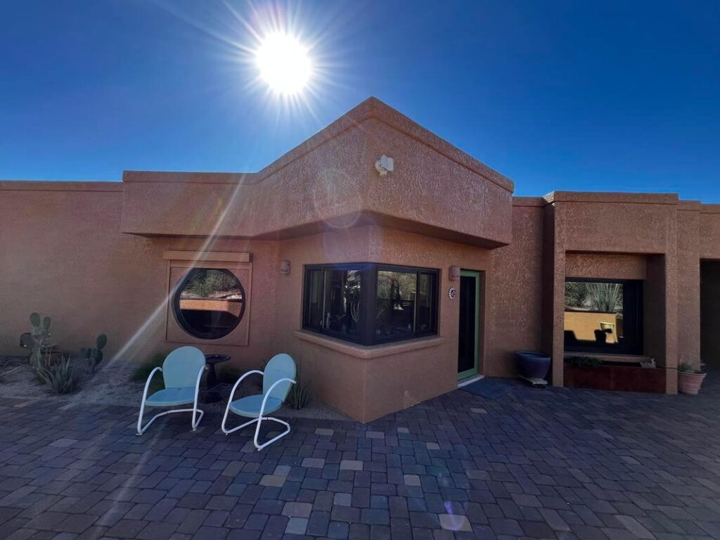 Beautiful adobe-style home painted by Piper Family Painting Company, showcasing Vail Painting Company craftsmanship with earthy tones and desert landscaping.